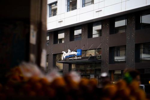 a building with a sign in front of it at Radisson Blu Hotel Casablanca City Center in Casablanca