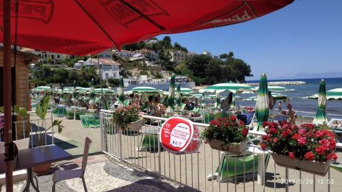 a beach with a bunch of chairs and umbrellas at B&B Oasi Rooms in Agropoli
