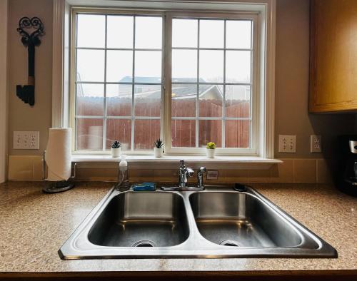 a kitchen sink in front of a window at The Getaway SE Boise Condo Across the street from Greenbelt, Bown Crossing and Boise River 3BD 3Bath, 4 beds! Lovely, Homey, Dining table seats 6 in Boise