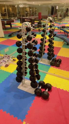 a row of dumbbells on the floor of a gym at سويت ابحر سكن خاص SUITE OBHUR private accommodation in Jeddah