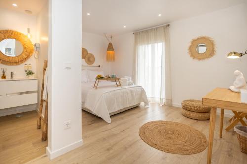 Un dormitorio con una cama y una mesa. en CASA BRISA, MAR E SOL SESIMBRA, en Sesimbra