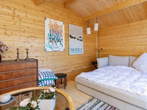 a bedroom with a bed in a wooden cabin at 3 person holiday home in Karrebæksminde-By Traum in Karrebæksminde