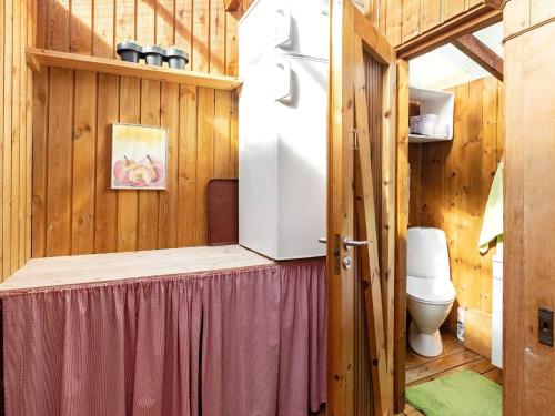 a small bathroom with a refrigerator and a toilet at 3 person holiday home in Karrebæksminde-By Traum in Karrebæksminde