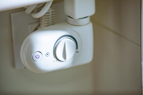 a white mixer sitting on a counter in a bathroom at Apartamentos Villa Zoila Nigrán in Nigrán