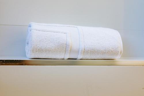a white towel sitting on a shelf at Apartamentos Villa Zoila Nigrán in Nigrán