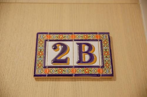 a sign on a wall with the number on it at Apartamentos Villa Zoila Nigrán in Nigrán