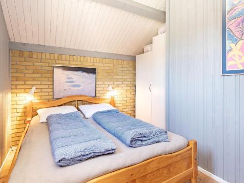 a bedroom with a bed with two blue sheets at Two-Bedroom Holiday home in Askeby 2 in Askeby