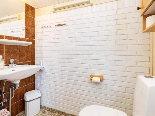 a bathroom with a white toilet and a sink at Two-Bedroom Holiday home in Askeby 2 in Askeby