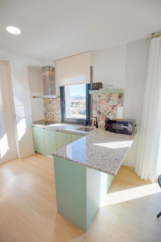 a kitchen with a counter top in a room at Apartamentos Villa Zoila Nigrán in Nigrán