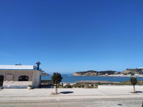 a building with a view of the ocean at Apartment by the beach! With large balcony! in São Martinho do Porto