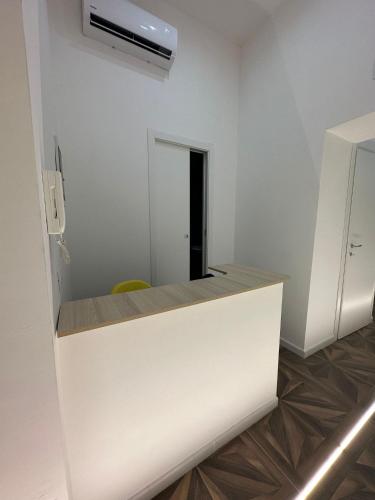 a kitchen with a white counter and a refrigerator at San Ferdinando suite room in Naples