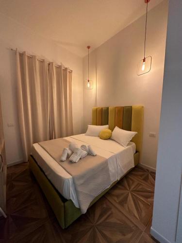 a bedroom with a bed with two towels on it at San Ferdinando suite room in Naples