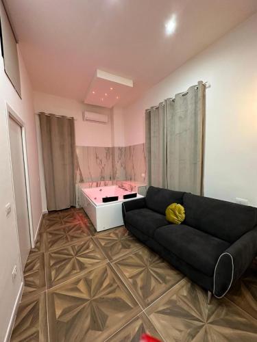 a living room with a couch and a tub at San Ferdinando suite room in Naples