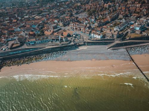 an aerial view of a beach and a city at The Wave - 3 bed beach front home in Sheringham in Sheringham