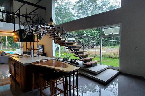 a kitchen with a spiral staircase in a house at CR Caribbean Blue House - Modern style 100 WiFi in Cahuita