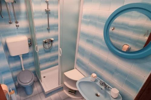 a bathroom with a sink and a toilet and a mirror at Apartments and rooms with parking space Supetar, Brac - 5658 in Supetar