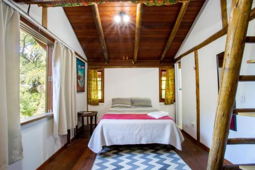 a bedroom in a house with a bed in it at Casas Temporada Aldeia Niura Opy in Florianópolis