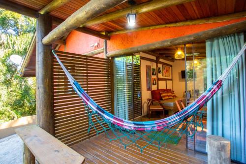 a hammock on the porch of a house at Casas Temporada Aldeia Niura Opy in Florianópolis