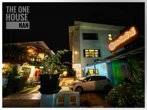 a car parked in front of a building at night at The One House in Nan