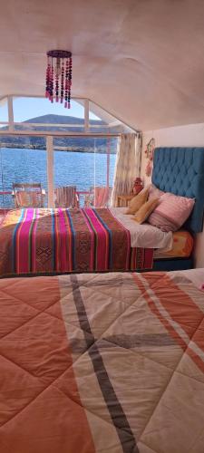 a bedroom with two beds on a boat at Uros TITICACA home lodge in Puno