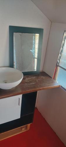 a bathroom with a sink and a mirror on a counter at Titicaca Home Perú in Puno