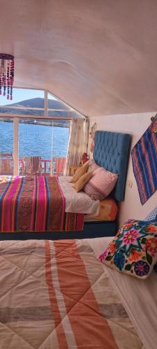a bedroom with two beds on a boat at Uros TITICACA home lodge in Puno