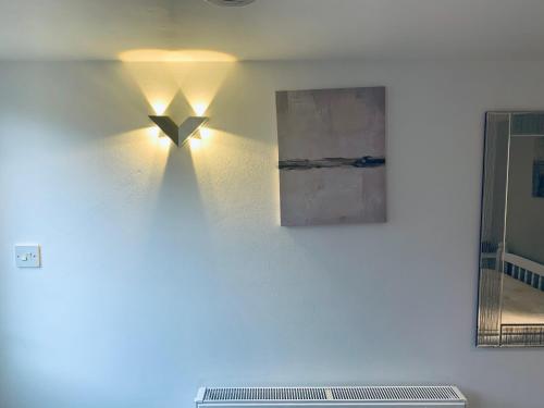 a light on a wall with a picture on it at Deluxe Double Room with Private Amenities in Banbury