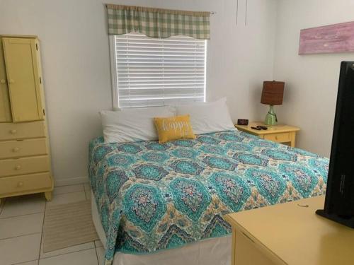 a bedroom with a bed with a pillow on it at Lovely 1 Bedroom Unit Across from Lido Key Beach in Sarasota