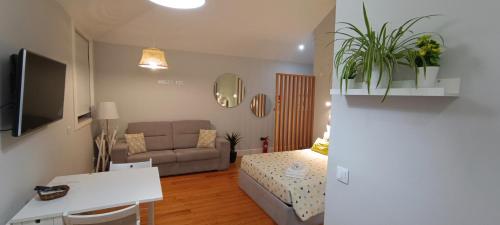 a small living room with a couch and a table at S Bento Boutique Apartment in Porto