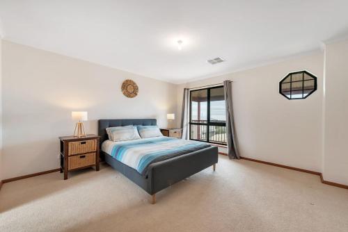 a large bedroom with a bed and a window at 10 Rupara - Linen Included in Hayborough