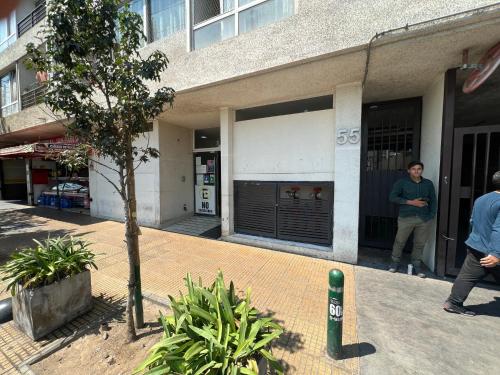 a man is standing outside of a building at Departamento Cómodo y Luminoso in Santiago