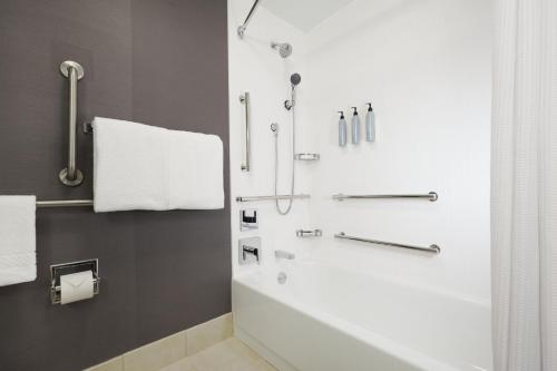 a bathroom with a shower with a shower curtain at Courtyard by Marriott St. Louis Downtown West in Saint Louis