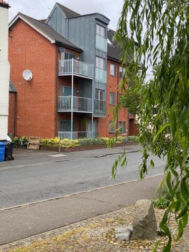an empty street in front of a brick building at Apt 5a Central by river 1 Bed Apartment in Norwich