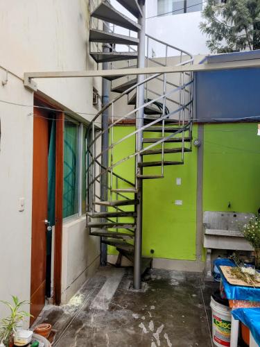 a building with a fire escape on the side of it at Habitación con baño propio para 2 personas como máximo in Lima