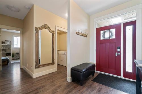 una stanza con una porta rossa e uno specchio di 3 bed, 2 bath upper suite overlooking the city a Vernon