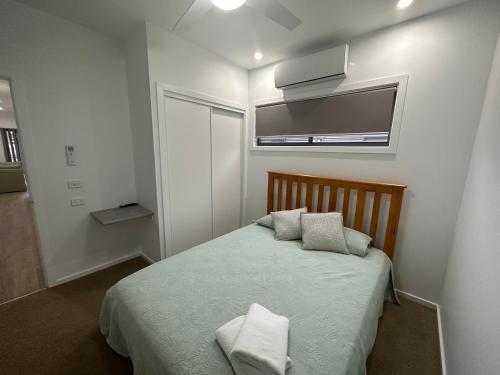 a bedroom with a bed with two pillows on it at Bundalong Villas in Bundalong