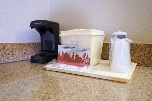 a coffee maker sitting on a counter next to a blender at Rosen Inn at Pointe Orlando in Orlando