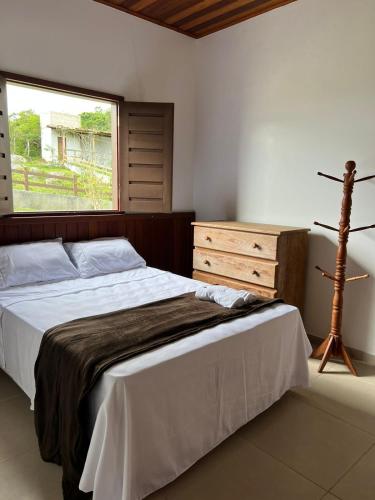 a bedroom with a large bed and a window at Casa da Serra Negra in Bezerros