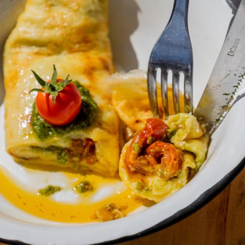a plate of food with a fork and a piece of food at Tatajuba Hostel Casa Pascual in Tatajuba