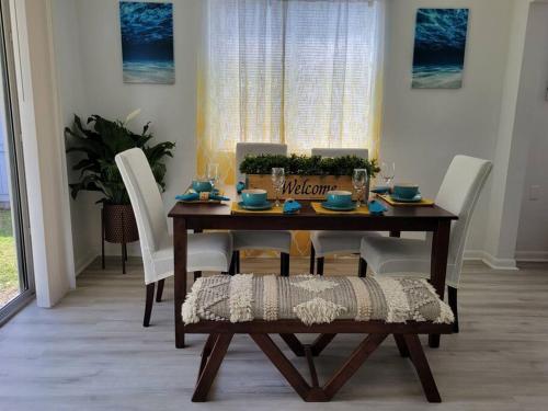 a dining room table with white chairs and a wooden table at Sol Miami # 2 with free parking in Miami