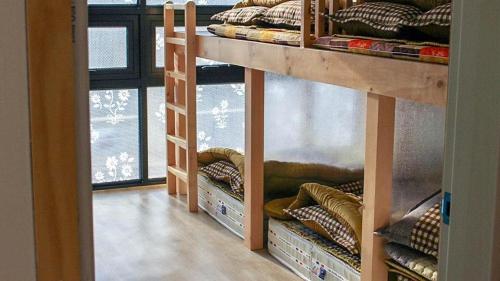 a room with three bunk beds in a room at Sogeum Gangsan in Gyeongju