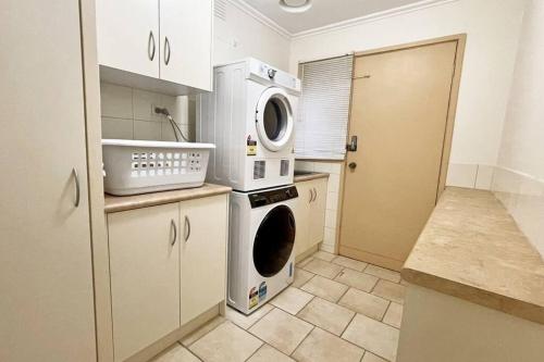 a kitchen with a washer and dryer in it at Stylish Retreat Family House 5BRM Wheelers Hill in Wheelers Hill