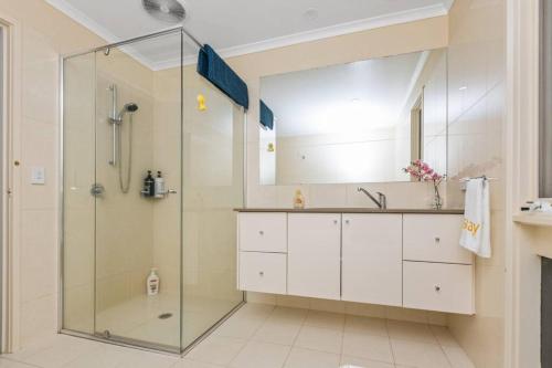 a bathroom with a glass shower and a sink at Stylish Retreat Family House 5BRM Wheelers Hill in Wheelers Hill