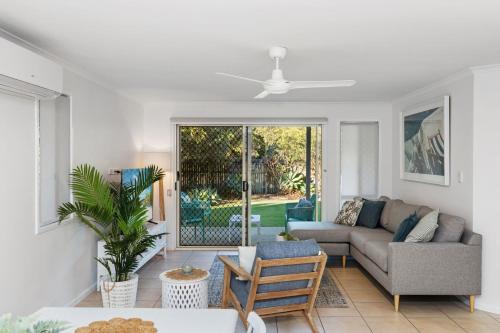 a living room with a couch and a table at Unit 1 Marcoola Shores in Marcoola
