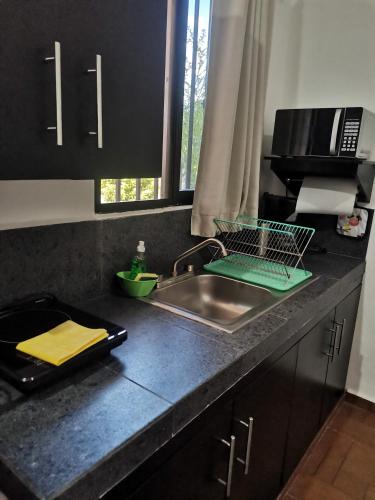a kitchen counter top with a sink and a sink at VILLA DEL CIELO TIXPEHUAL in Tixpehual