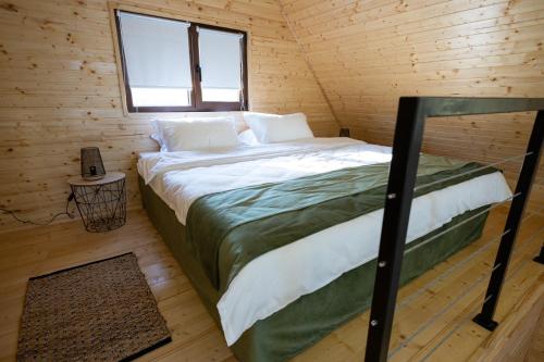 a bedroom with a bed in a wooden cabin at MILLAR's in Sovata