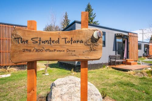 a wooden sign in front of a house at Stunted Totara, Unit 5 in Twizel