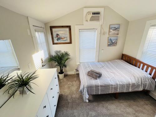 a bedroom with a bed and two windows at Alwaves Family 3 Bedroom Beach Apartment in Wildwood