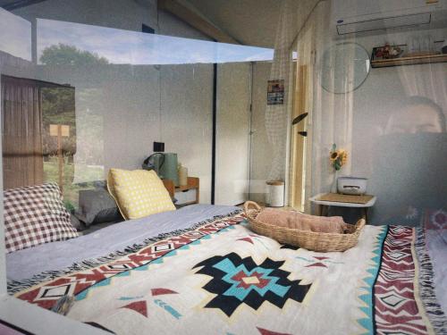 a bedroom with a bed with a quilt on it at Phu Morinn Cafe &Camping Monjam in Mon Jam