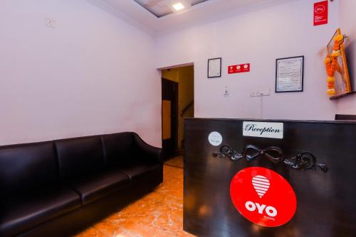 a living room with a black couch and a red heart at OYO Hotel Stayland Near Juhu Beach in Mumbai